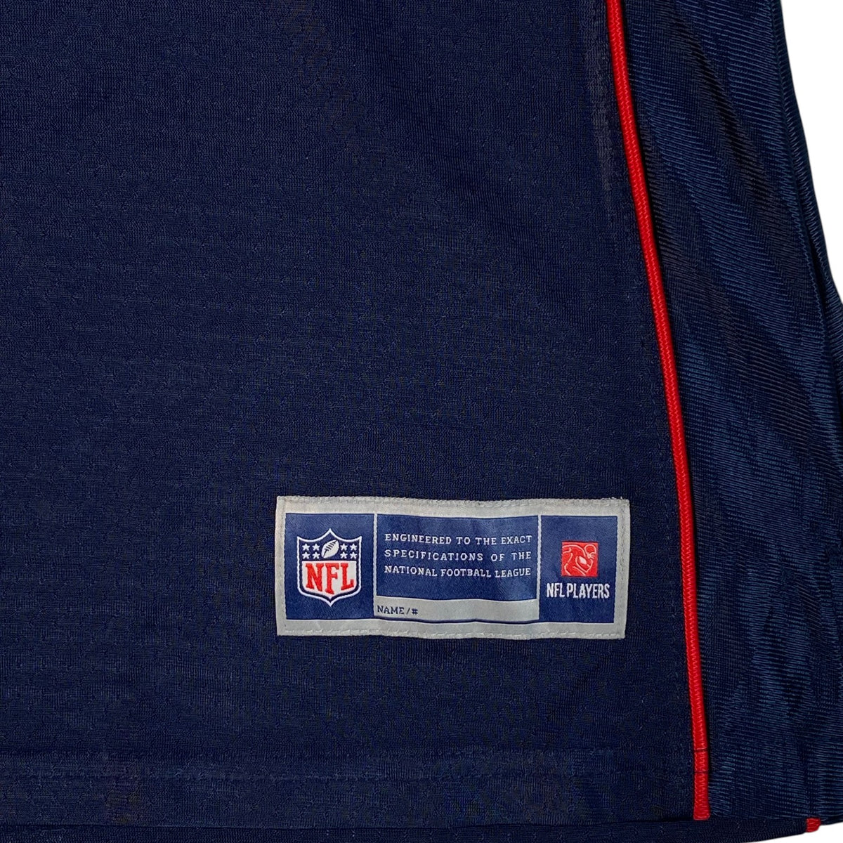 Digg It Thrift & Vintage New England Patriots NFL jersey jock tag detail in navy blue with red trim