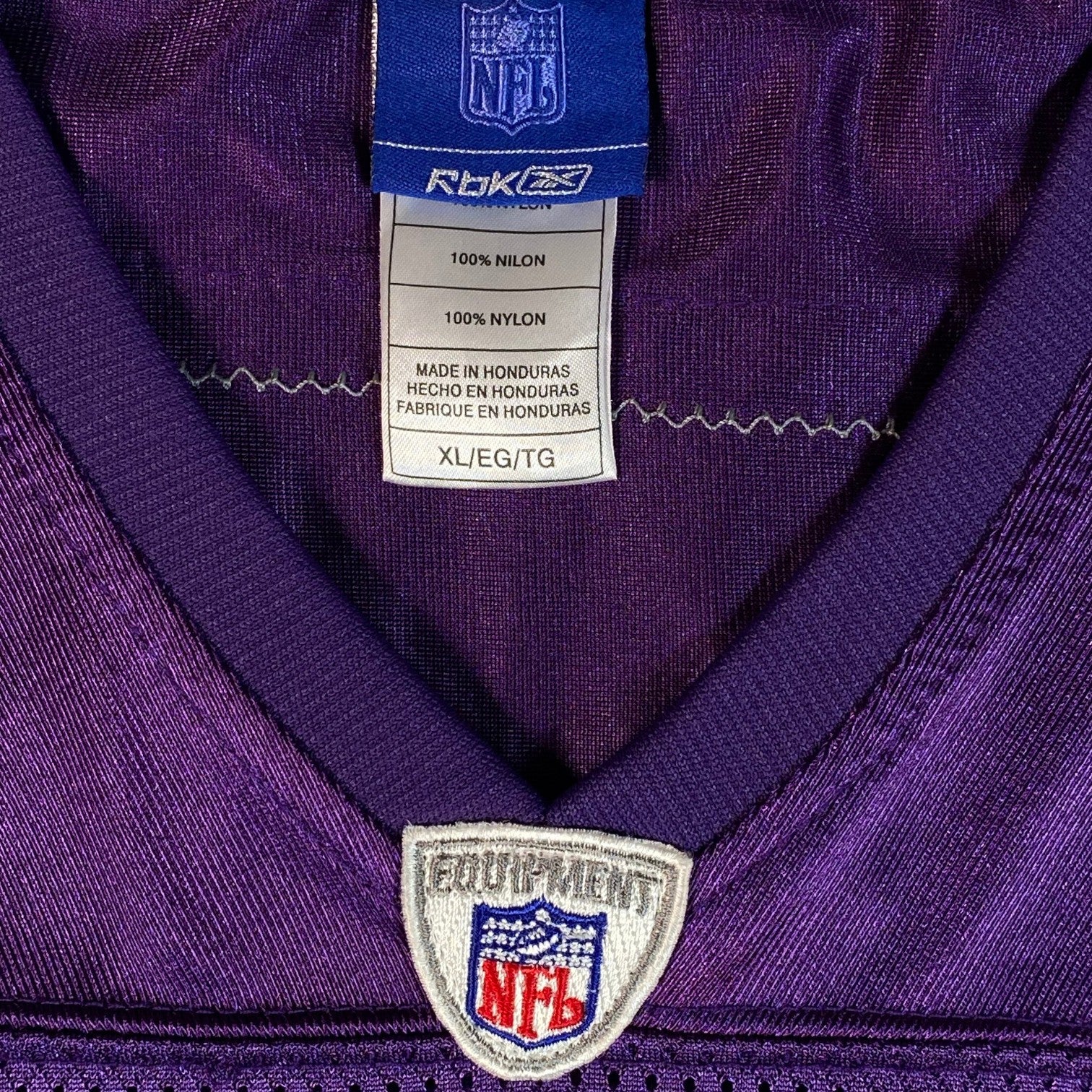 Digg It Thrift & Vintage Reebok NFL Minnesota Vikings jersey tag showing 100% nylon material and XL sizing