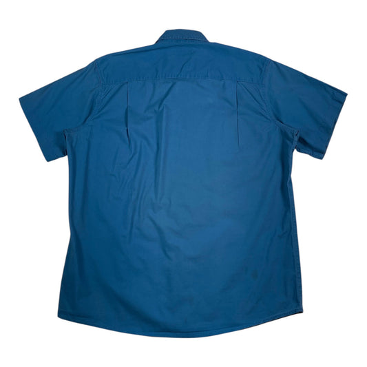Back view of a royal blue Carhartt short sleeve work shirt from Digg It Thrift & Vintage with a small stain.