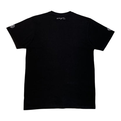 Back view of a black Stüssy x BAL Original x Hiroshi Nagai Yarigasaki Most Wanted T-Shirt from Digg It Thrift & Vintage