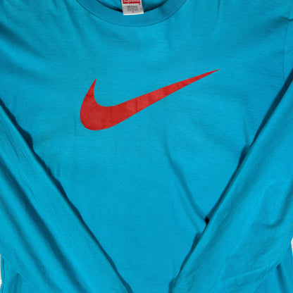 Digg It Thrift & Vintage teal blue long sleeve cotton t-shirt with a large red Nike swoosh logo on the chest.
