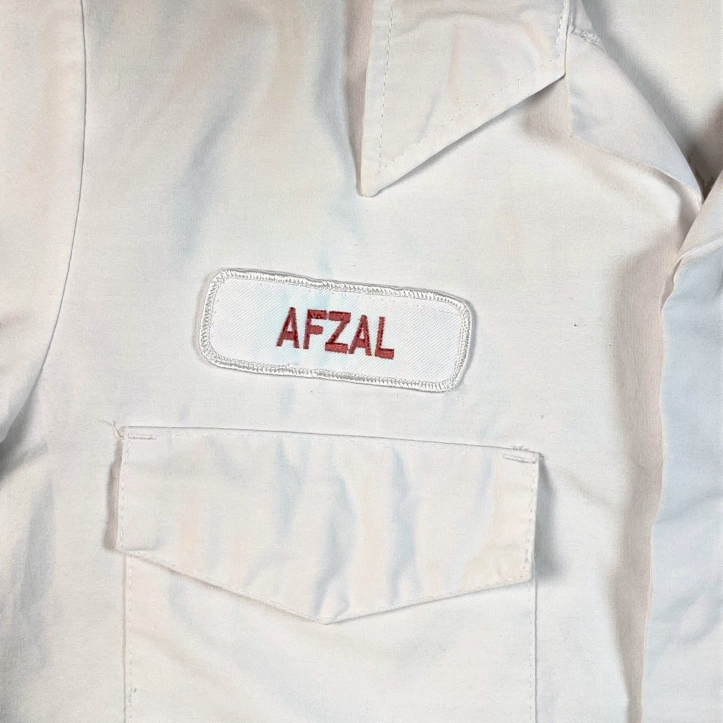 Digg It Thrift & Vintage white mechanic work shirt featuring an embroidered Afzal name patch above a chest pocket